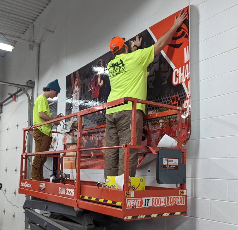 to men installing sign